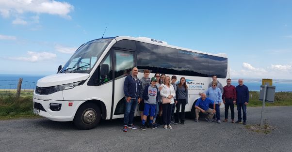 People standing outside Bus Tours Ireland bus